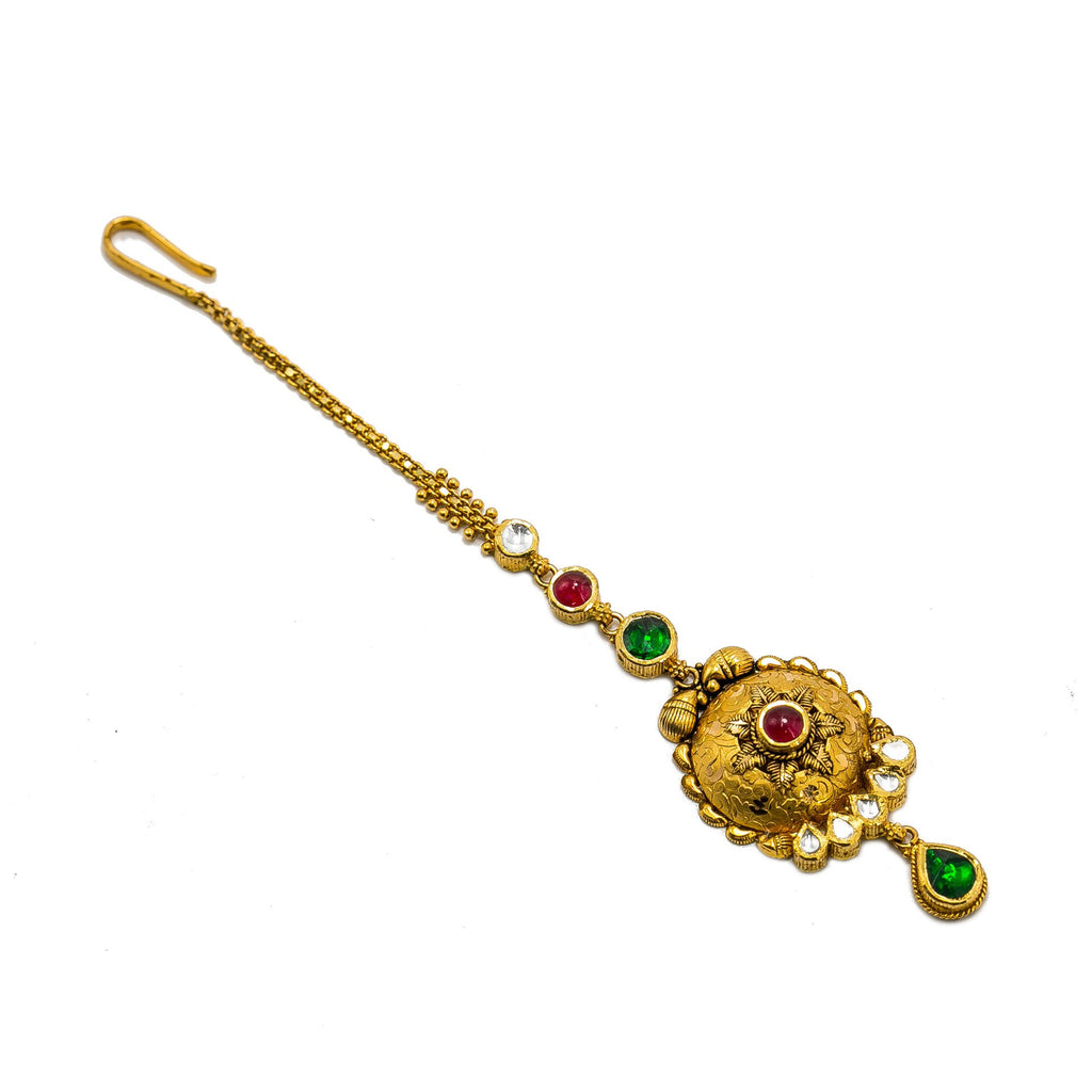 22K Yellow Gold Tikka W/ Ruby, Emerald & Kundan on Rounded Shield Design | 22K Yellow Gold Tikka W/ Ruby, Emerald & Kundan on Rounded Shield Design for women. Adorn yo...