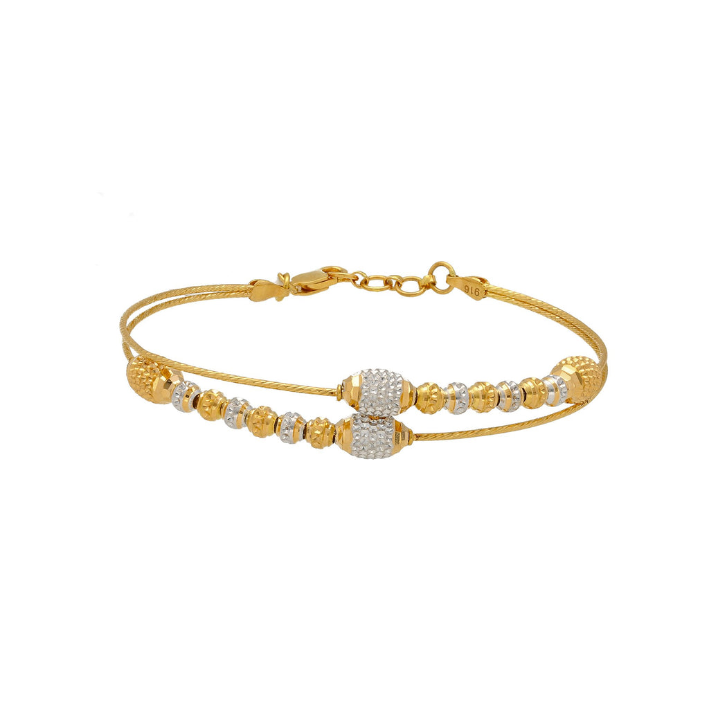 22K Multi Tone Gold Layered Bracelet  W/ Textured Gold Oblong & Ball Beads | 


Accessorize with the unique textures and designs of this 22K multi tone gold layered bracelet ...