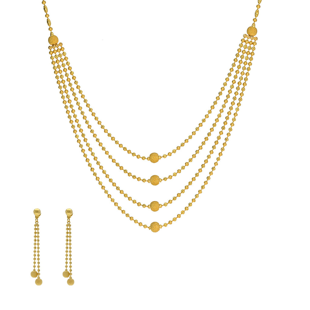 An image of a beautiful Indian jewelry set featuring a necklace and earrings from Virani Jewelers | Use this 22K yellow gold necklace and earring set from Virani Jewelers to add lustrous elegance t...