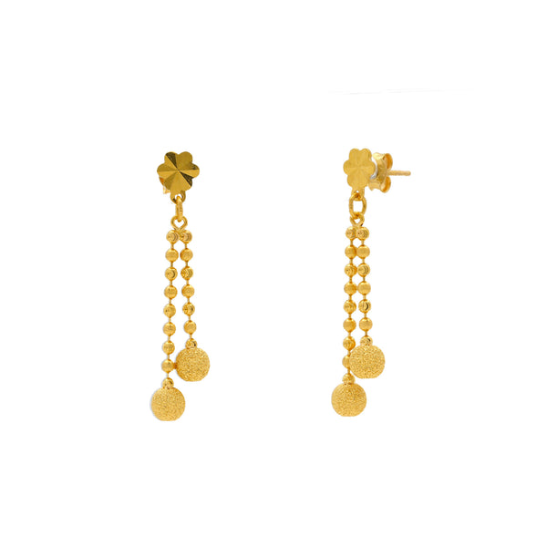A close-up image showing the side view of the Indian gold earrings with gold balls from Virani Jewelers. | Get charm and refinement in one 22K gold necklace set when you visit Virani Jewelers!

Crafted wi...