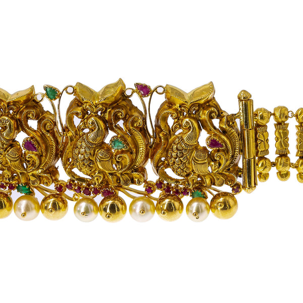 22K Yellow Gold Peacock Vaddanam Waist Belt W/ Emeralds, Rubies, Pearls & Detachable Centerpiece | Add movement and luxury to your most festive looks with Vaddanam waist belts that will transform ...