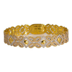 One multi-tone 22K gold bangle featuring butterfly and diamond-shaped cut-outs.