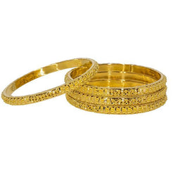 Set of four 22K yellow gold bangles from Virani Jewelers featuring beaded filigree around each band.