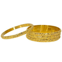 Set of four Indian gold bangles featuring stunning 22K gold and laser-cut details.
